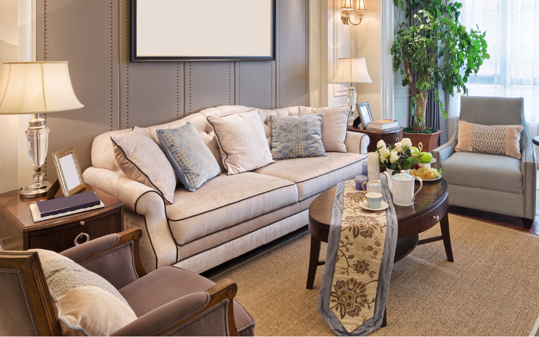 Living room with beige sofa, armchair, coffee table, and decorative elements.