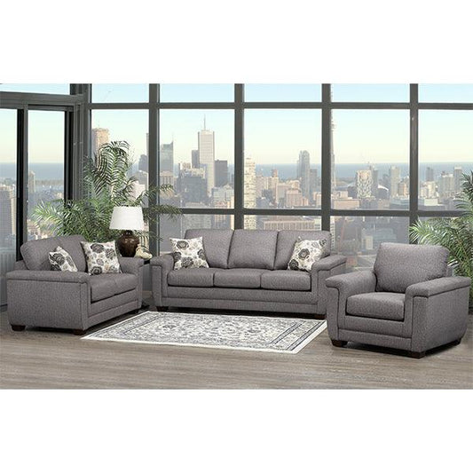 Gray sectional sofa in a living room with large windows showing a cityscape.