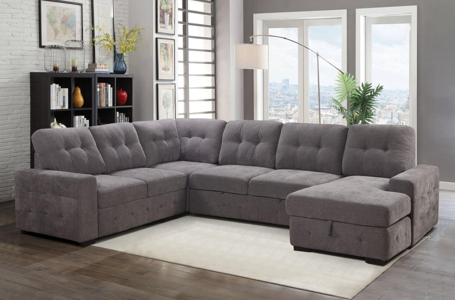 Gray sectional sofa in a living room with large windows and decor.